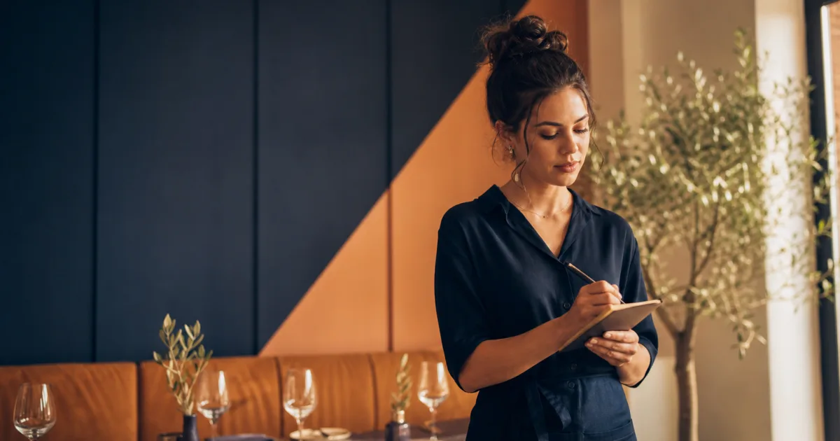 Restaurant team reviewing reservation notes for dietary and seating requests